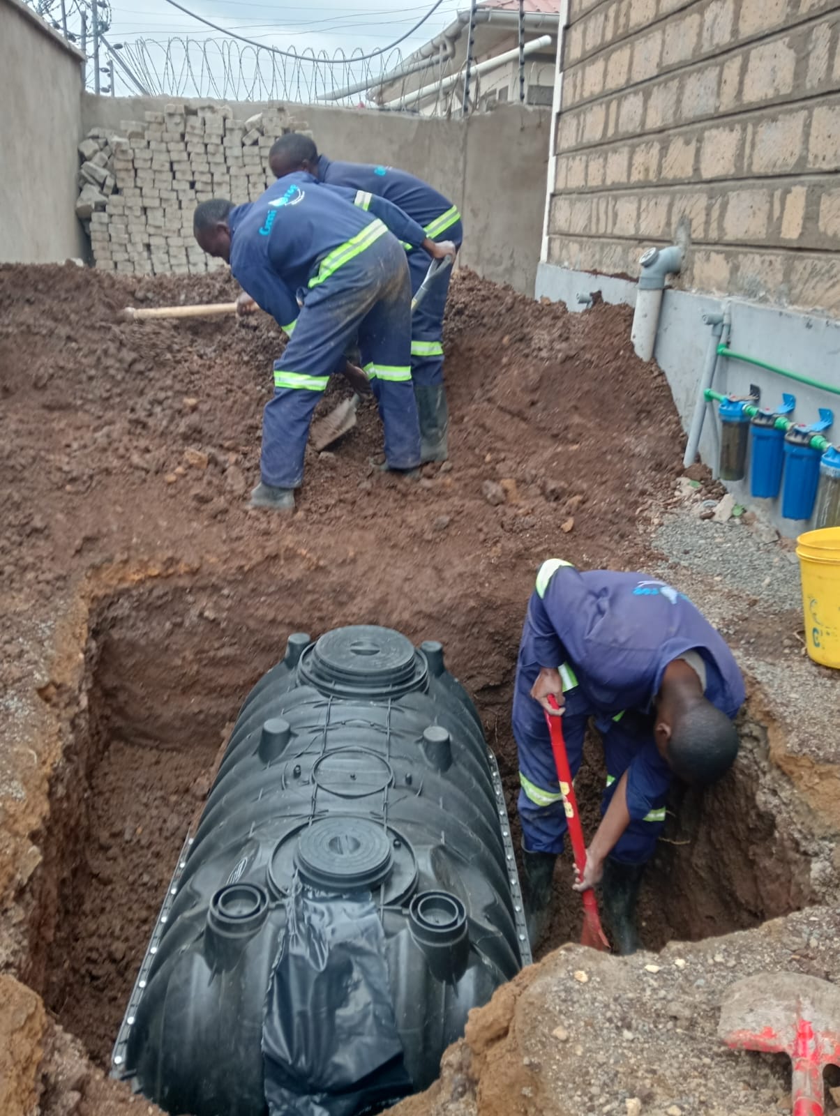 Omidrop Africa team constructing an anaerobic biodigester sanitation system at a residential property in Kenya